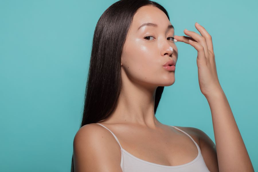 woman applies product to her nose